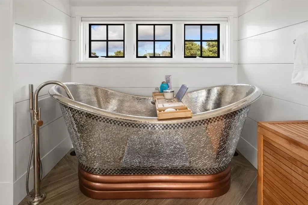 That metallic freestanding tub is wild. I’d soak until the water cools.