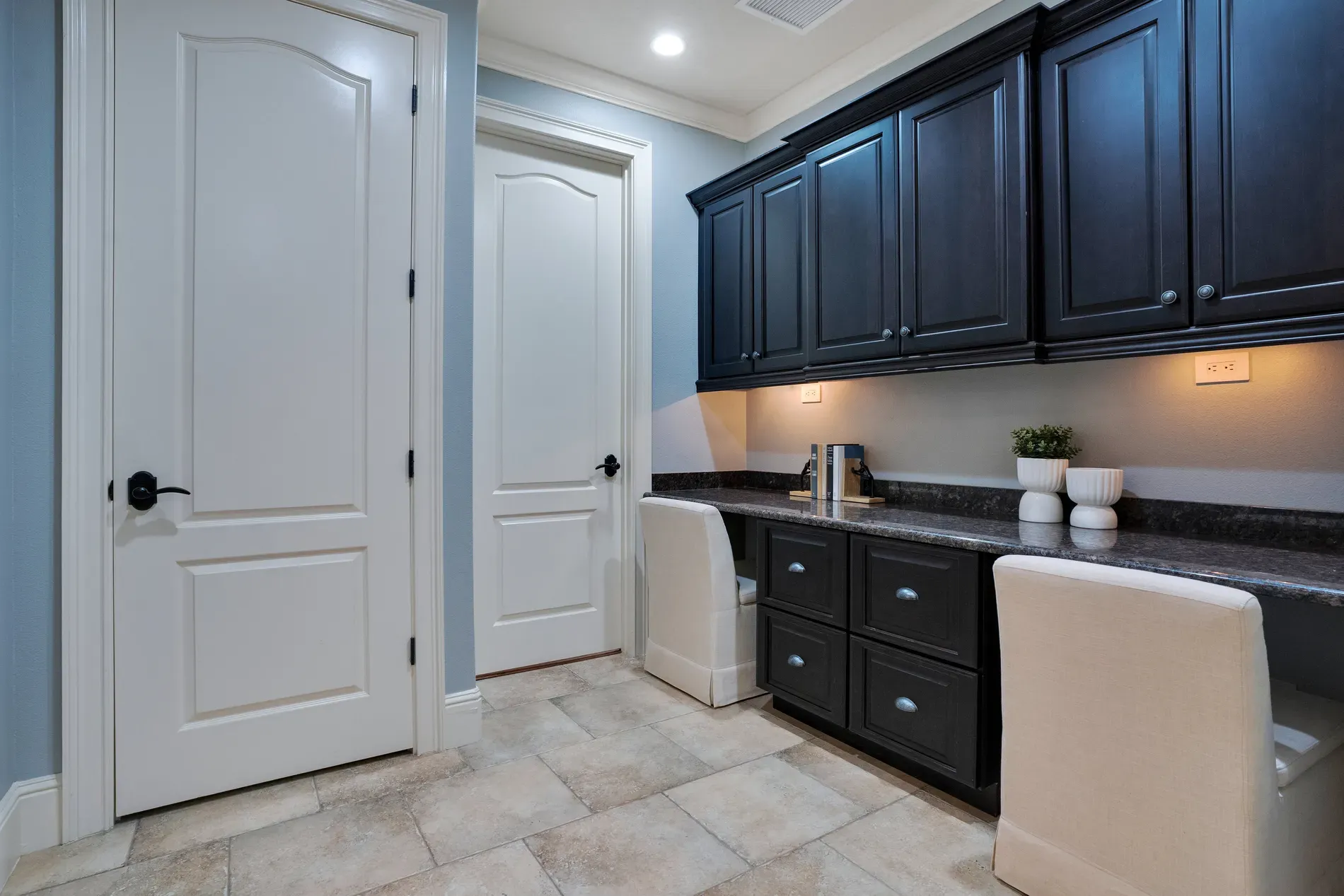 Tiny office setup — soft blue with tile floors. Clean, simple.