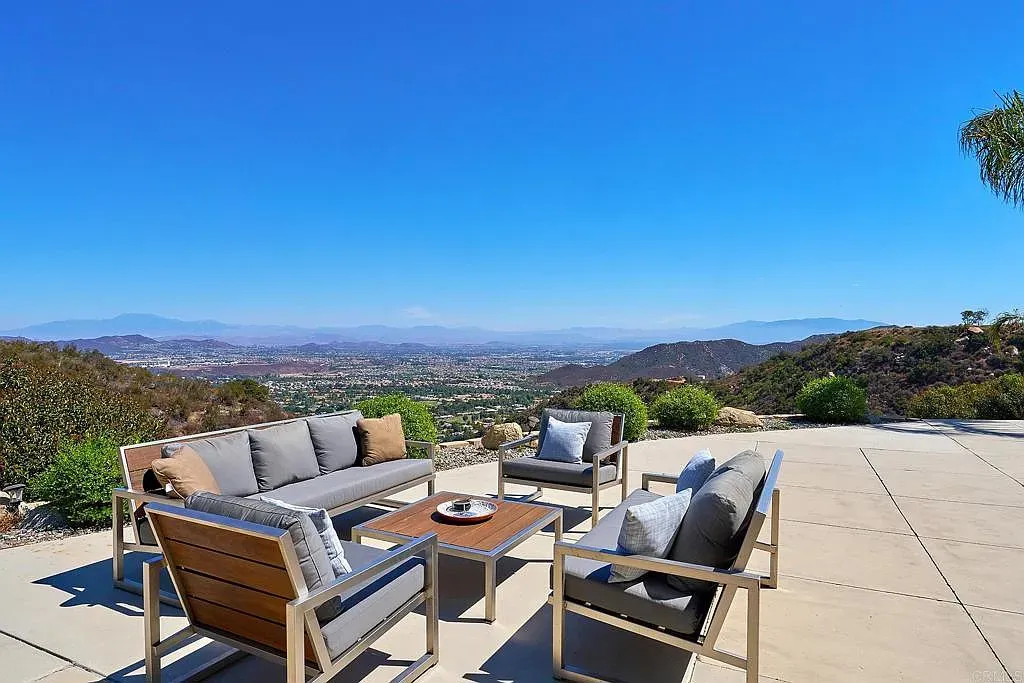 This terrace just stares at the hills forever. Sleek chairs, wood accents, done.