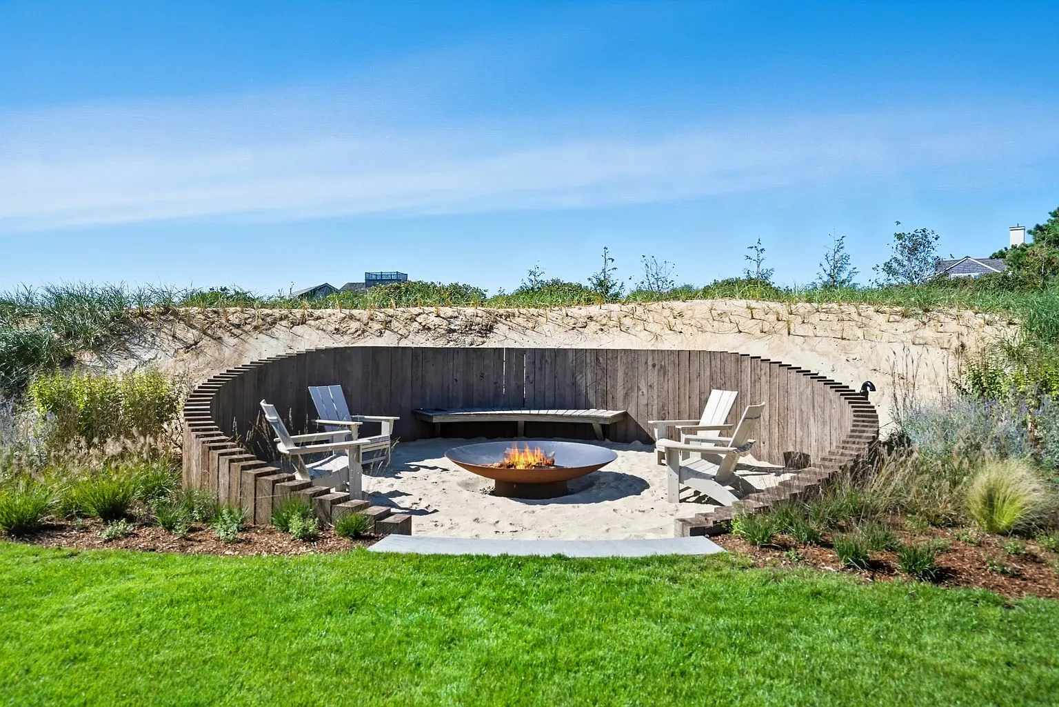 Circular fire pit zone with tall stone walls. Cozy or castle? Anyone know?