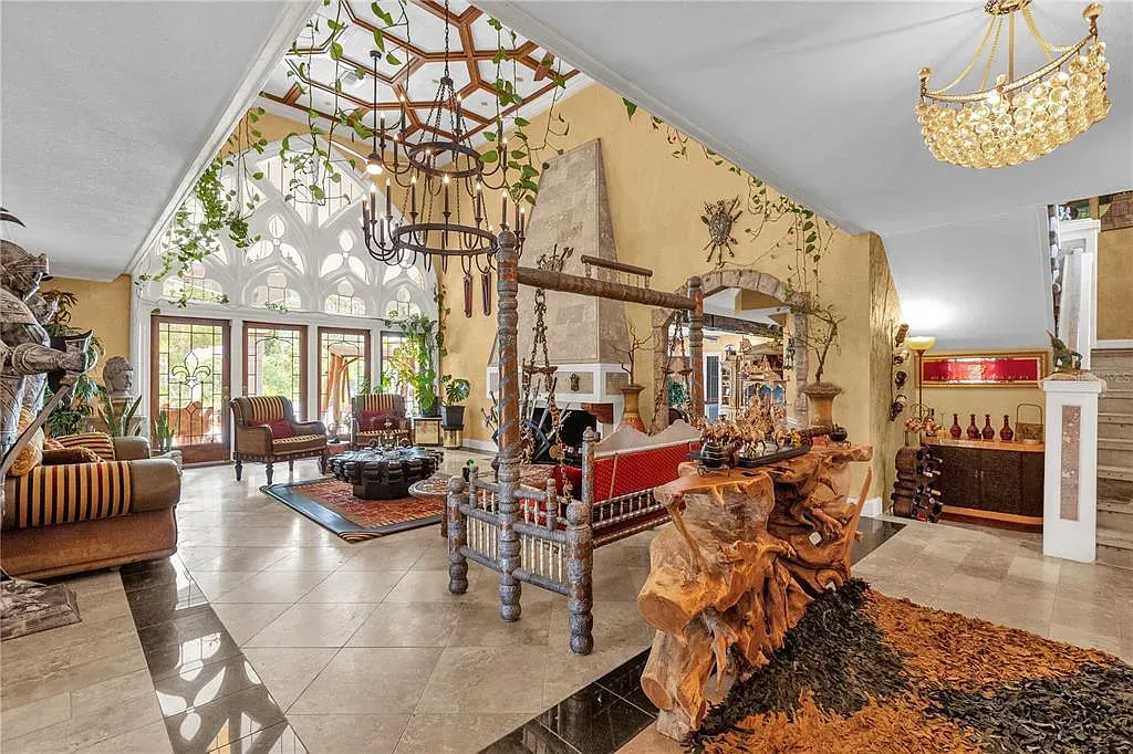 Entry with cathedral ceiling and greenery-draped chandeliers. A little dramatic, in a good way.