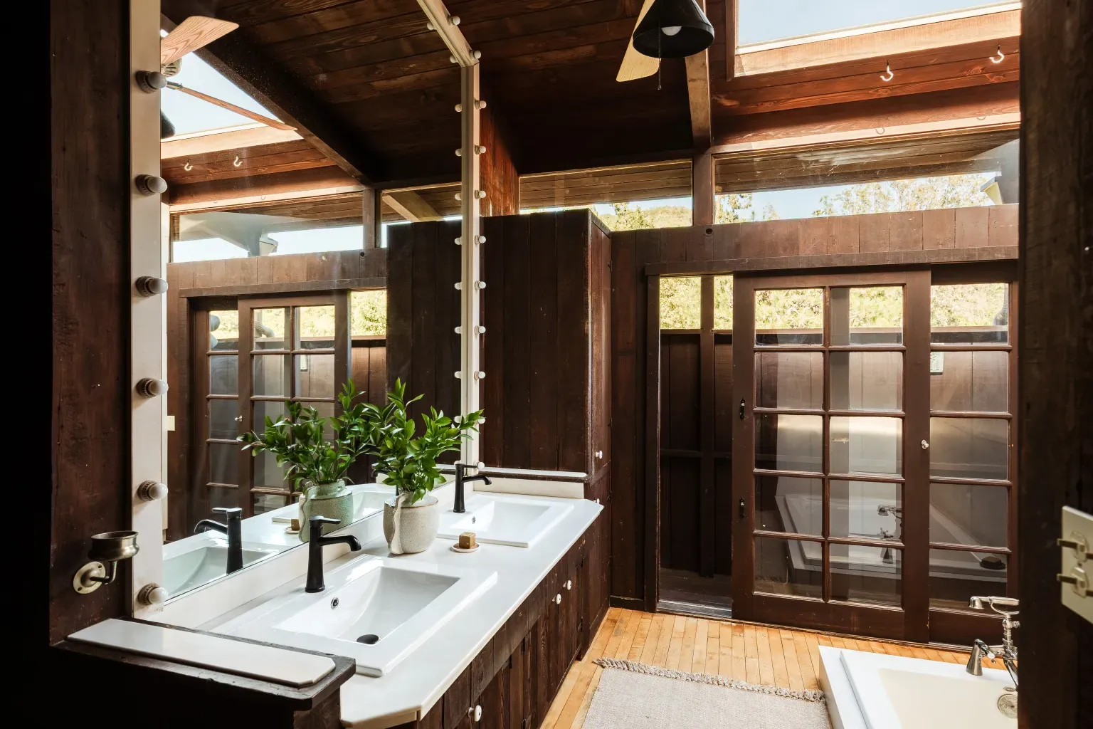 Spa bathroom with a wood ceiling and huge windows. I'd never leave.
