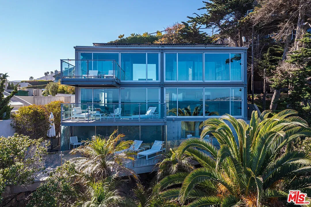 Glass-on-glass beach house, all windows and palms. Clean lines for days.