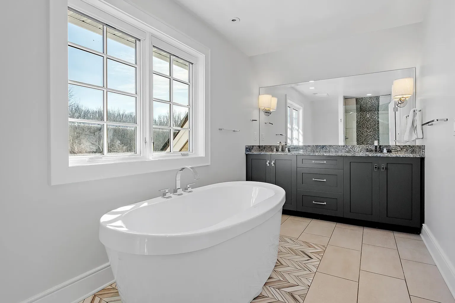 Freestanding tub by big windows. That soak would hit different.