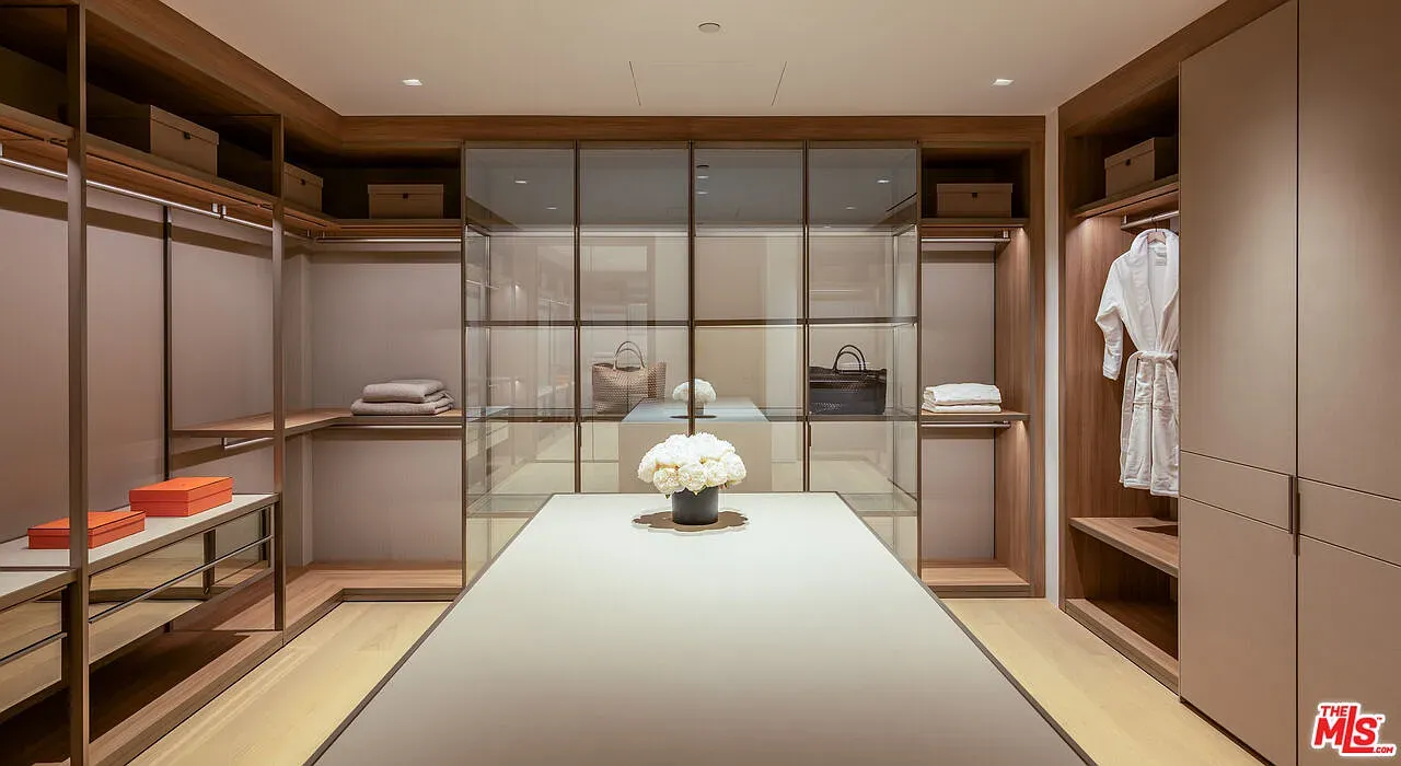 Closet goals — beige calm, walnut everything. Do socks get a valet here?