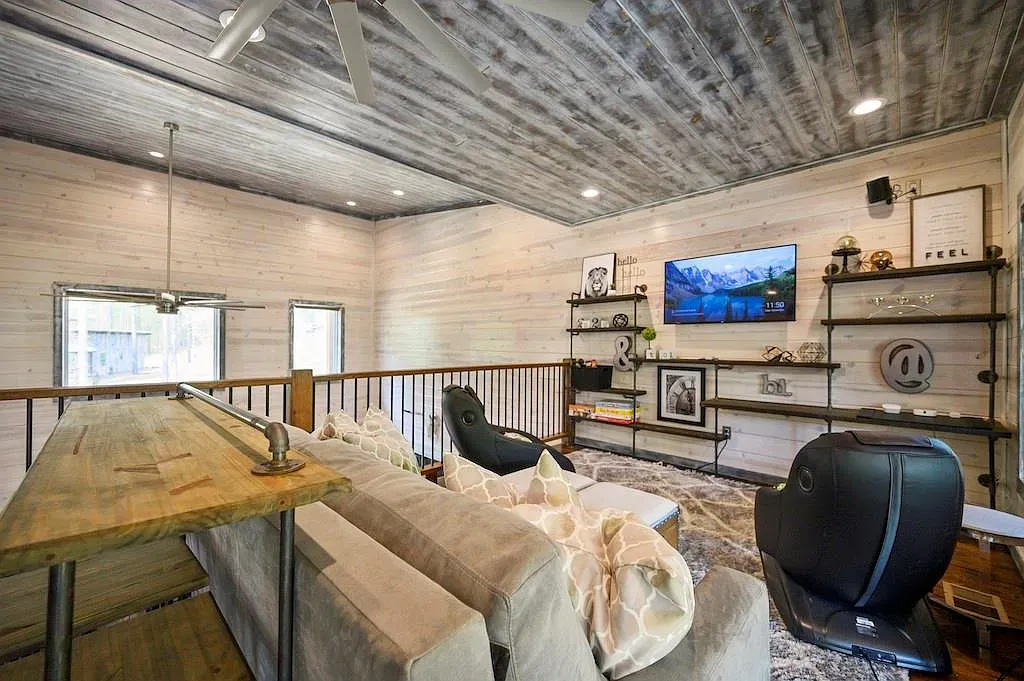 Loft living room with reclaimed wood ceiling and soft neutral everything.