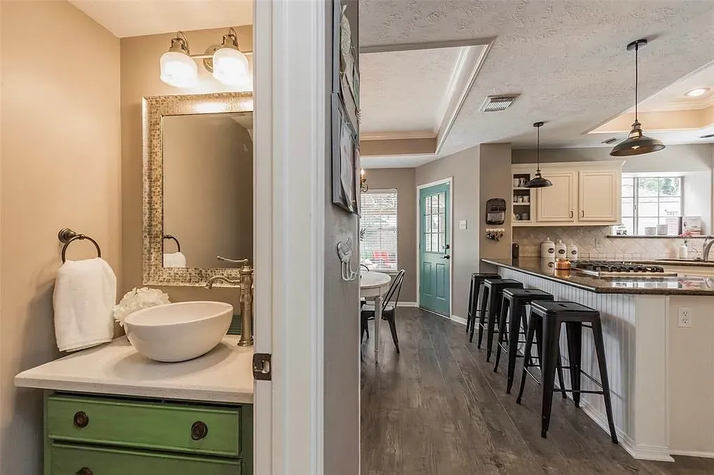Little bath with a green vanity pop. Rustic trim keeps it interesting.