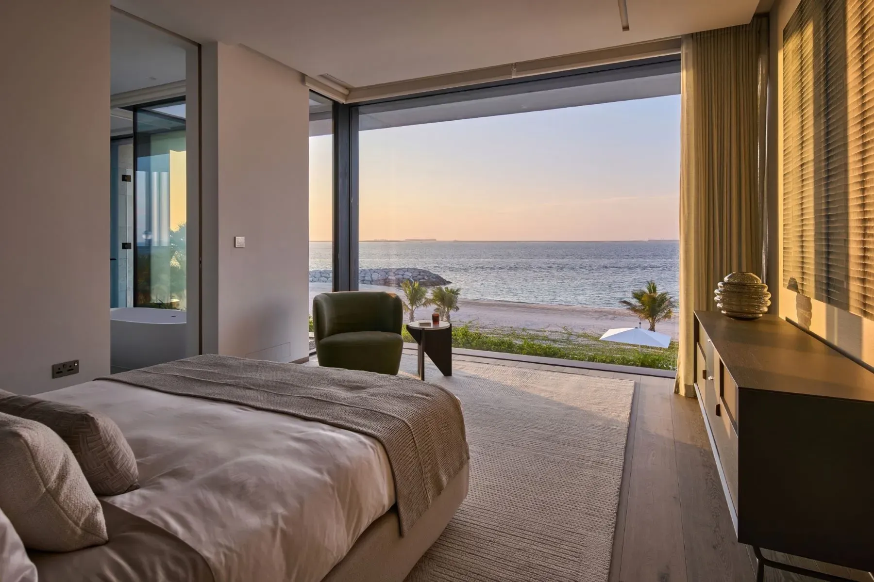 Primary bedroom goes soft sand colors with the big glass. Peaceful.