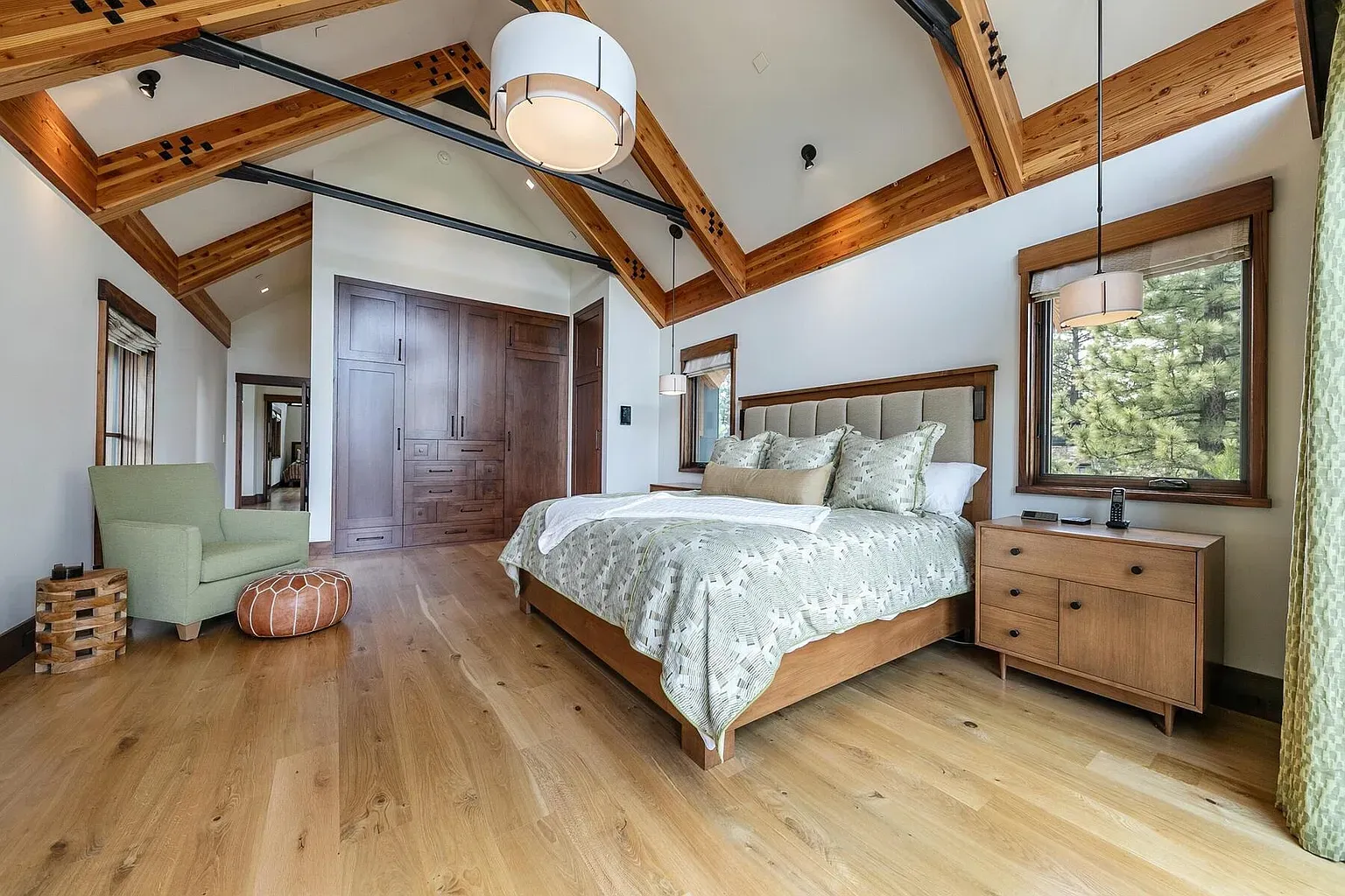 Vaulted ceiling with chunky beams. Warm wood and big windows. Easy to exhale.