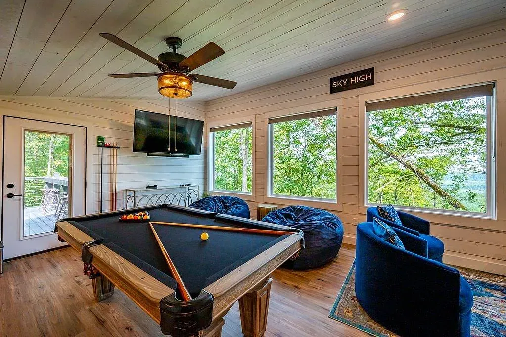Game room mood. Black pool table, warm floors, statement light ready for late nights.