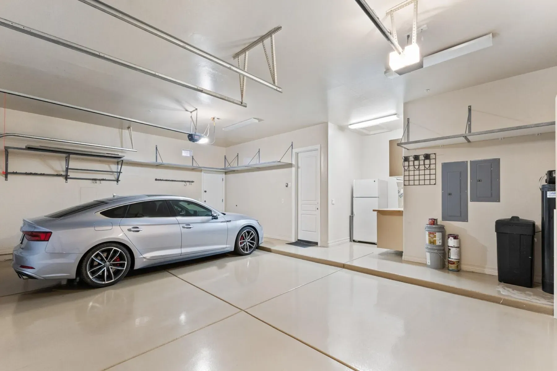 Clean garage with shiny concrete floors. So much room for bikes and boxes.