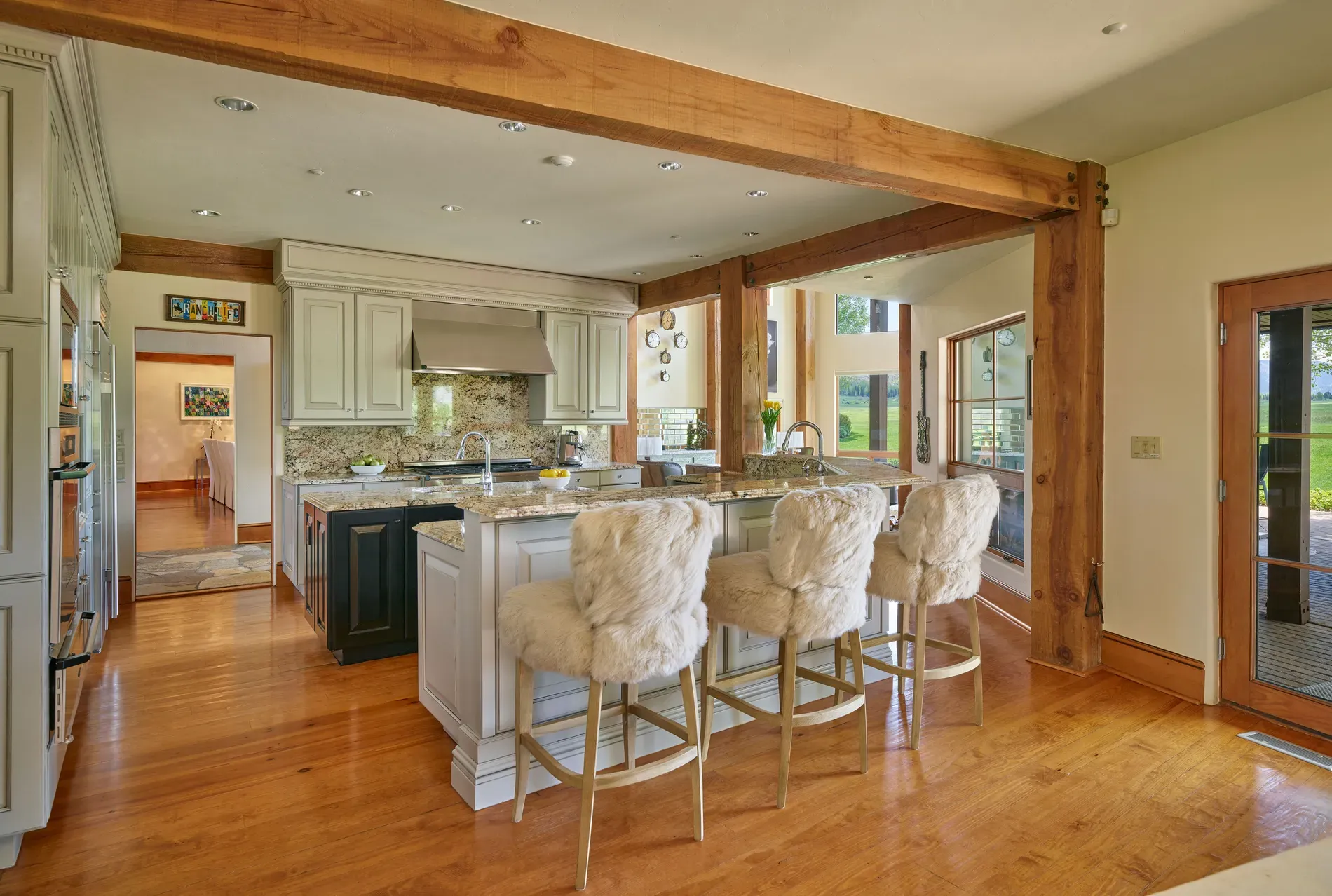 Here's the kitchen — big marble island, plush stools. From this angle, spotless.