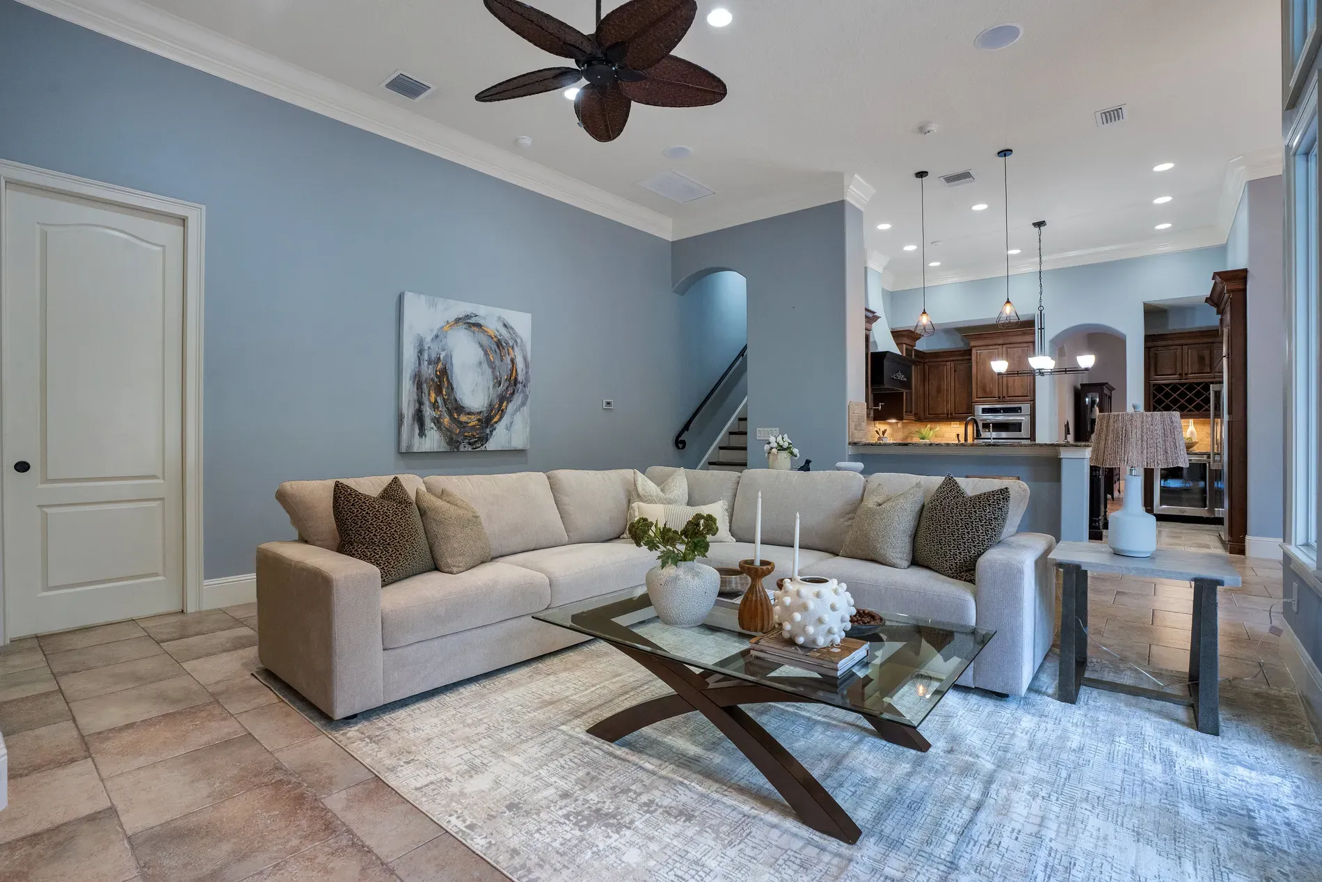 Big living area in blue-gray. Subtle ceiling texture. What's the focal piece?