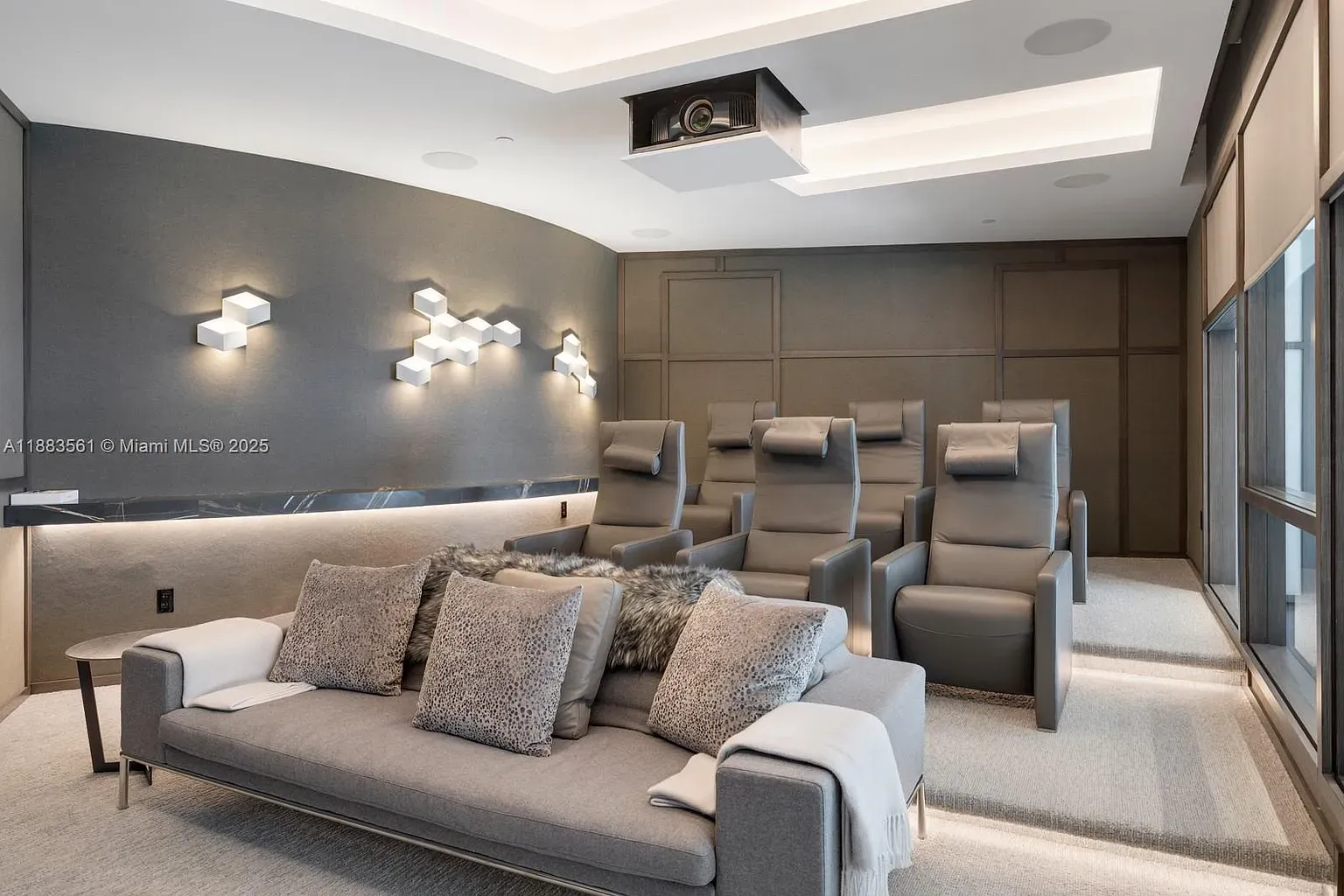 Home theater time. Dark, plush, hush vibes. Seats look dangerously nap-friendly.