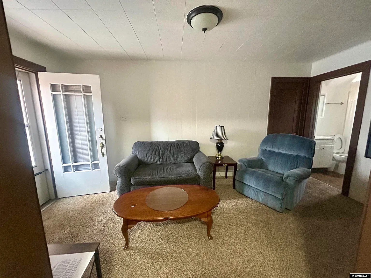 Little sitting room with twin blue chairs. Quiet corner for coffee and gossip.