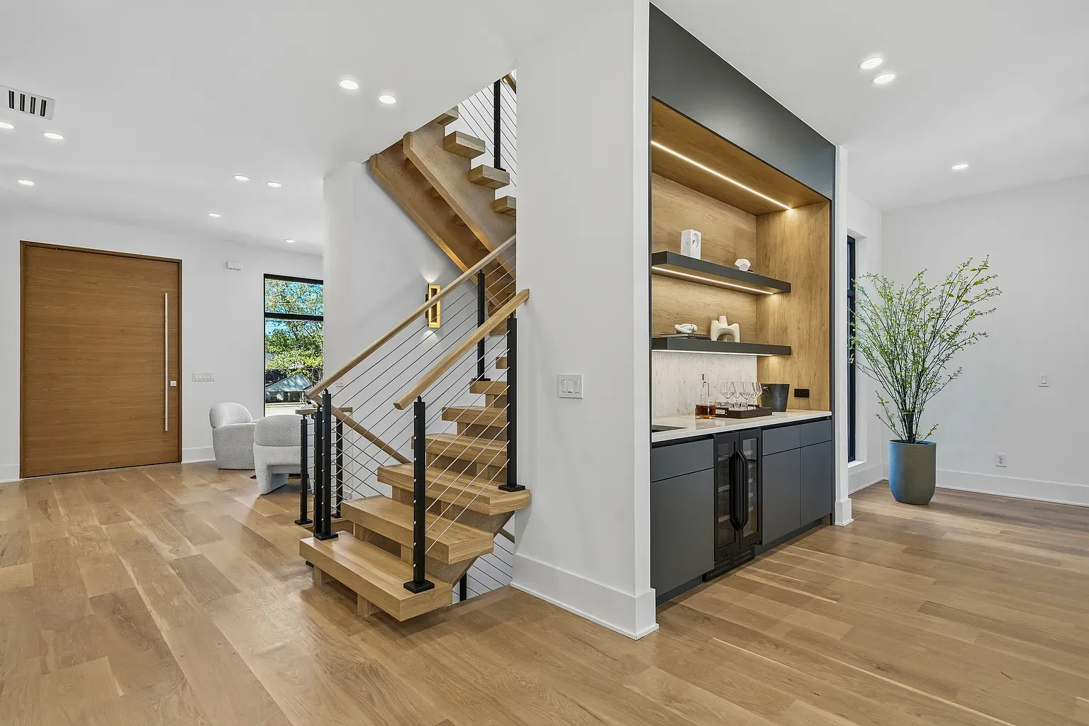 Entry flex with the open stairs. Thin iron railing looks custom.