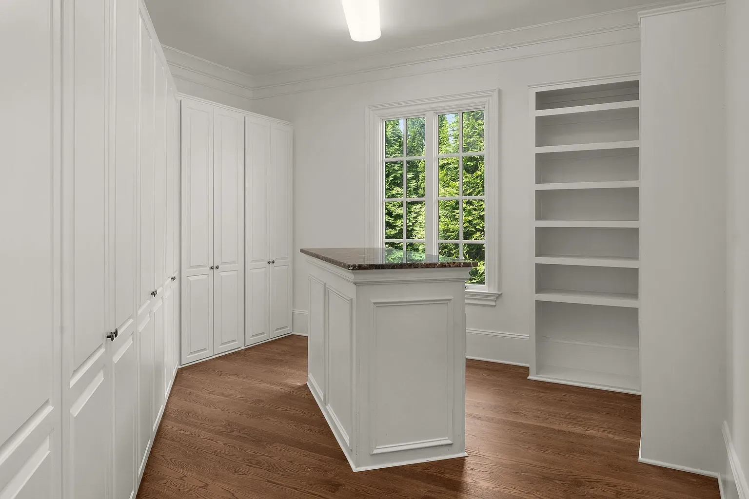 Built-in cabinetry wall, clean white everything. Could be office, craft room, laundry.