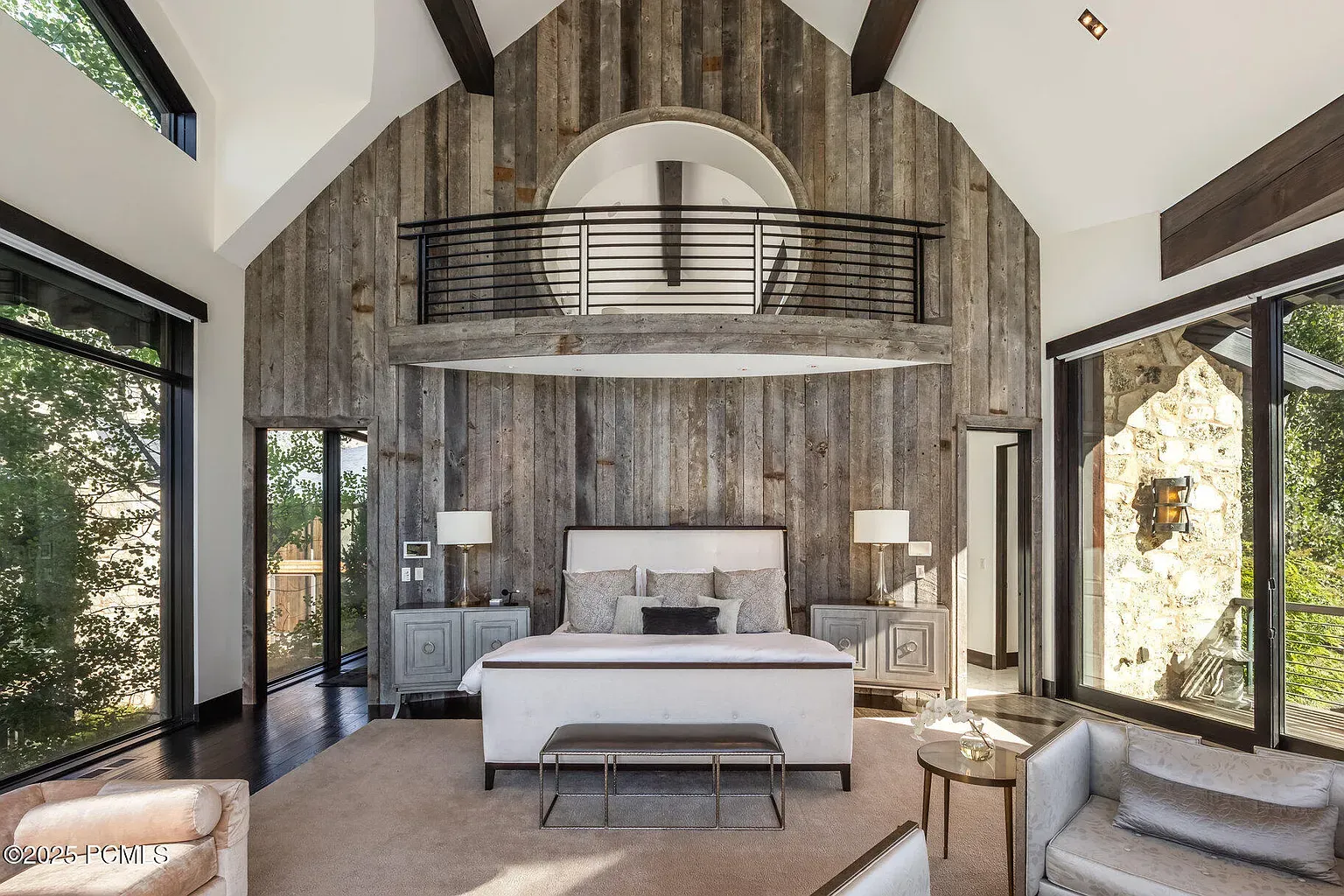 Bedroom with reclaimed wood wall. Warm grays, soft lighting, pretty calm.