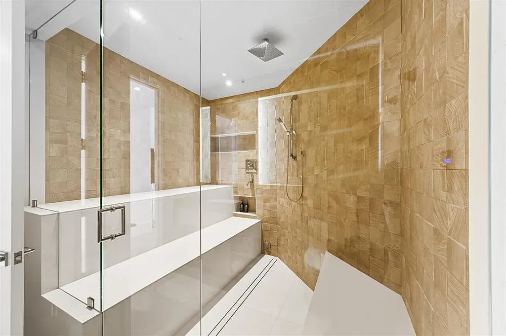 Warm wood-look tiles wrap the room. Feels a chic sauna upgrade.