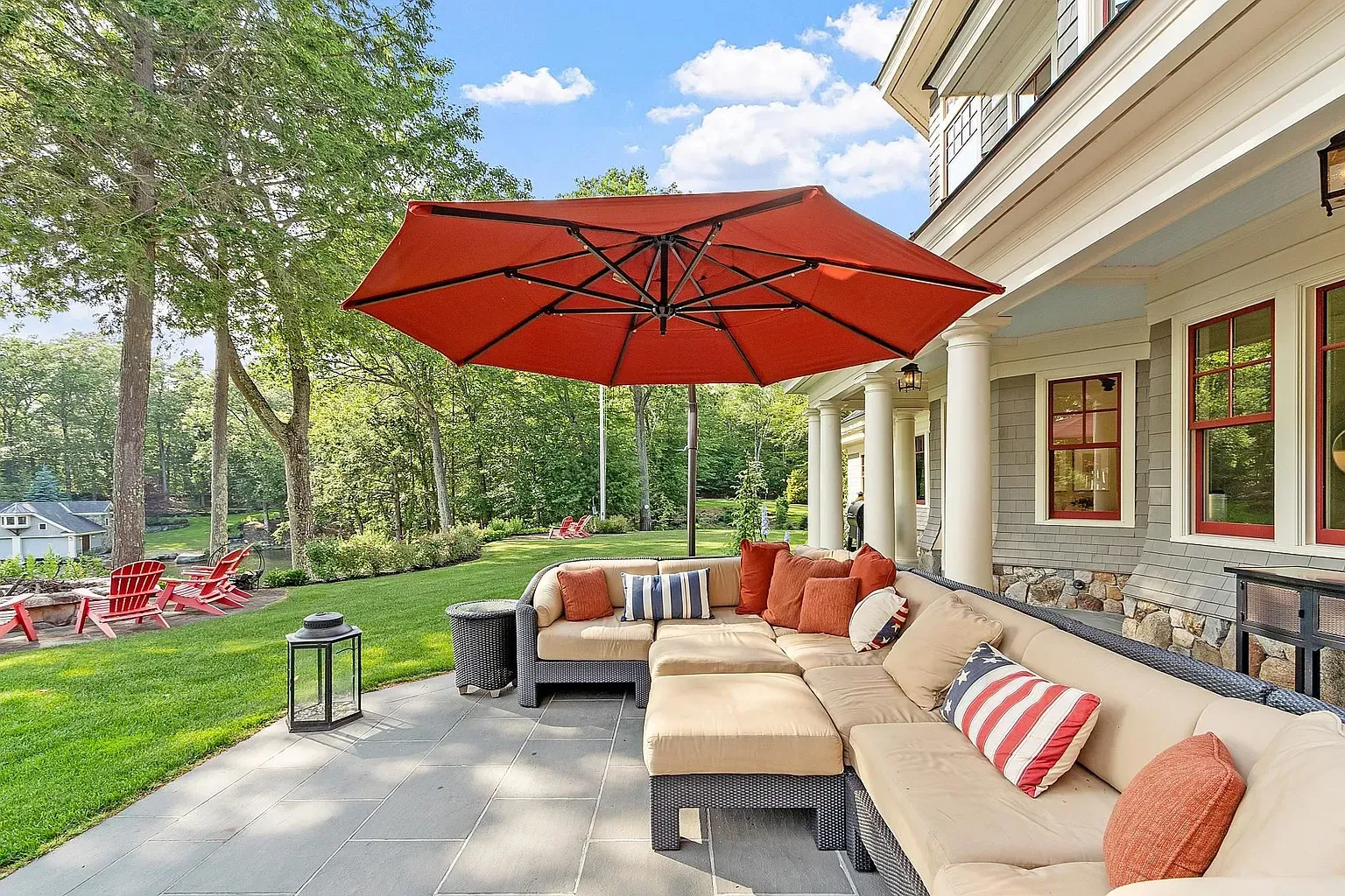 Big sectional, bold umbrella, looks an all-day hang spot.