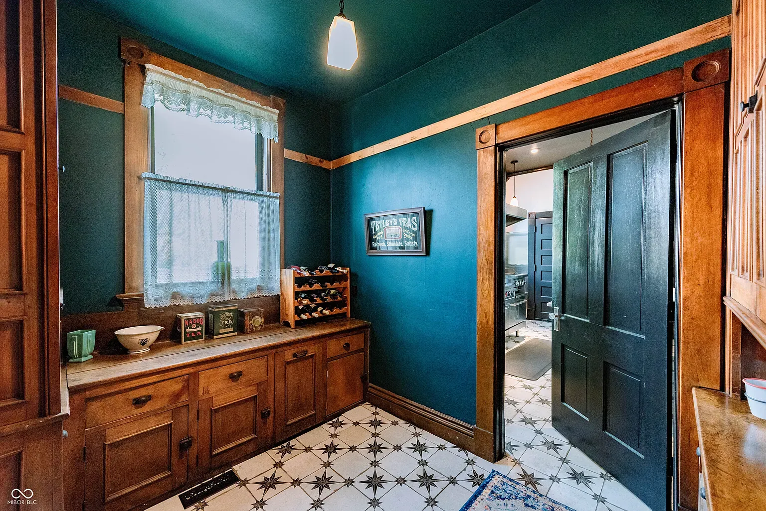 Deep blue with honey cabinets is unexpectedly perfect. Crown molding ties it together.