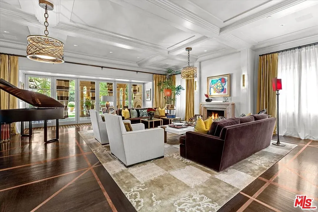 Dark velvet sofa with light chairs. That rug ties everything down.