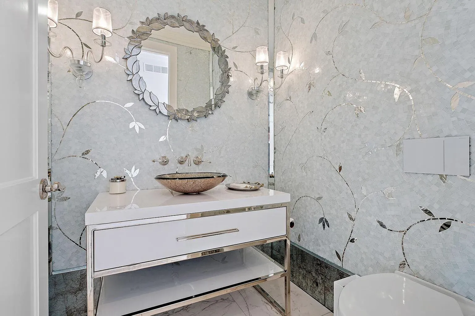 Shimmery blue mosaic bathroom with silver details. Mermaid energy, in a good way.
