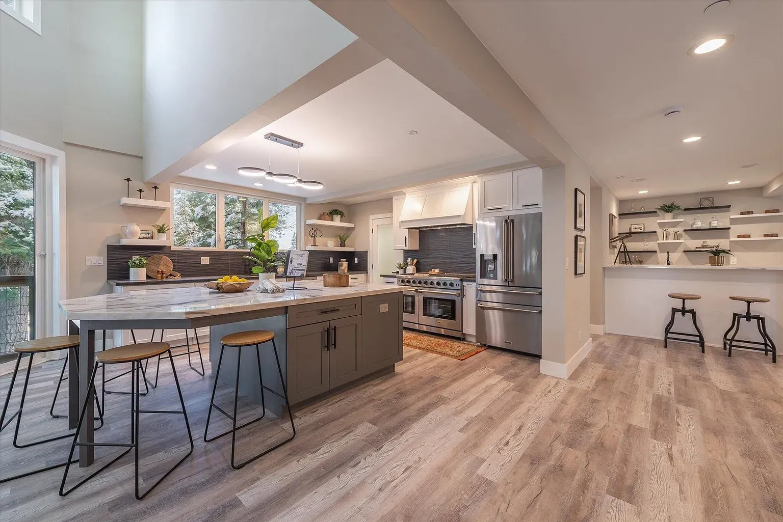 Neutral kitchen with warm wood floors. I’d actually cook here.