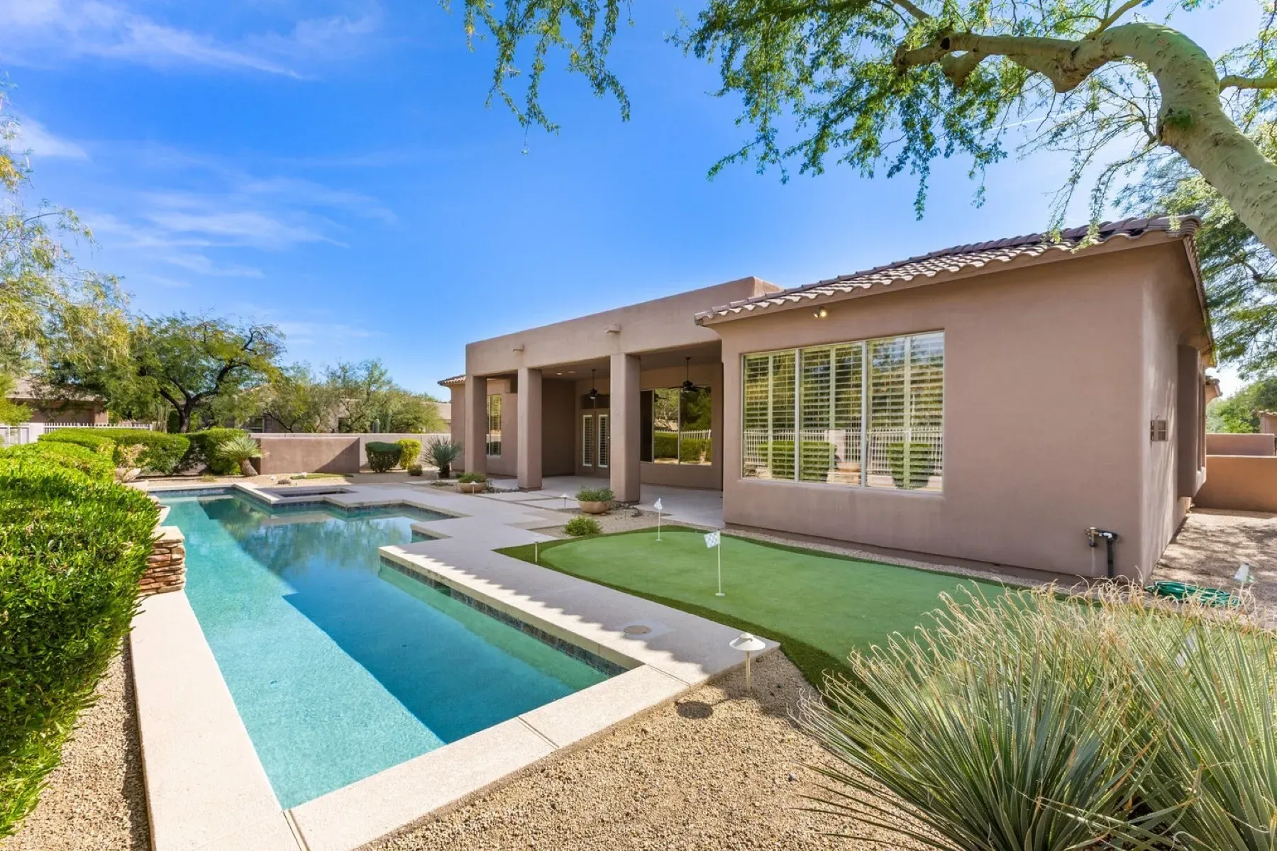 Soft beige exterior again, modern lines. Central patio situation? Looks calm.