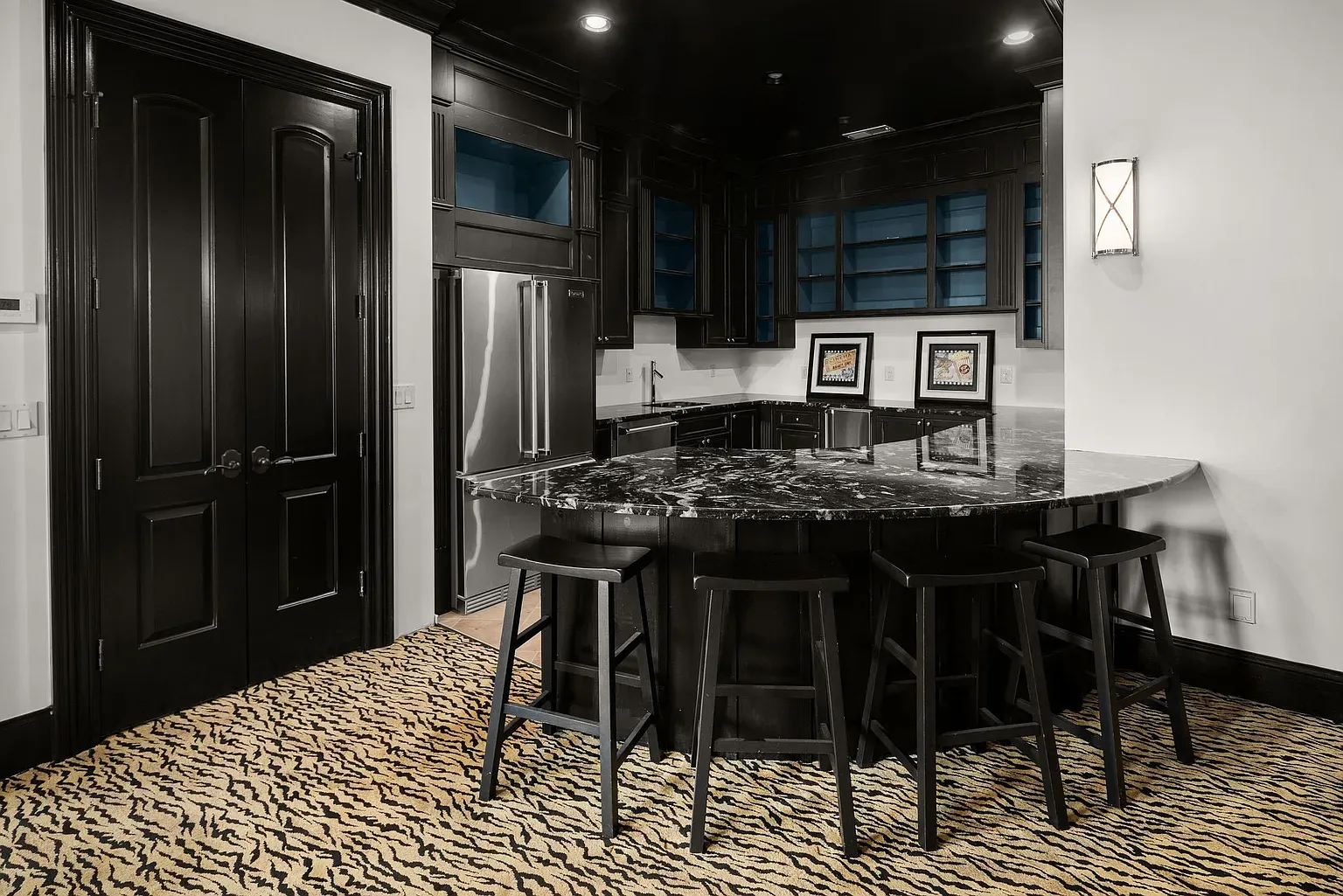 Black-on-black kitchen with marble and stainless. Looks sharp, probably hides my cooking disasters.