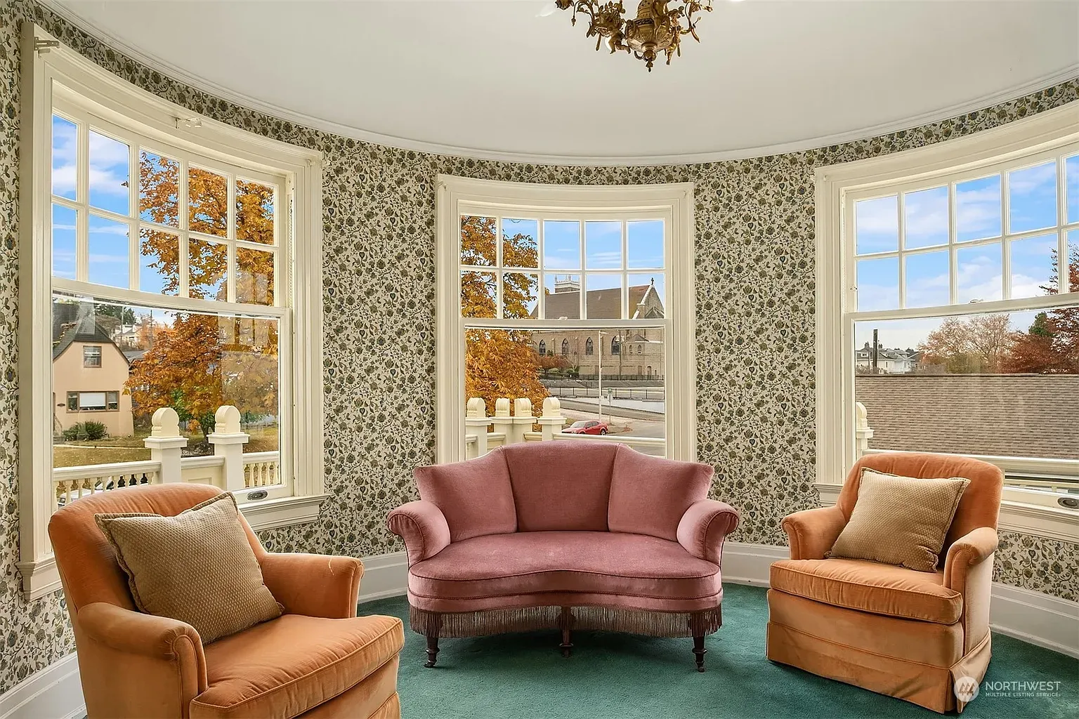 Round room with tall windows and floral wallpaper. Views doing all the work.