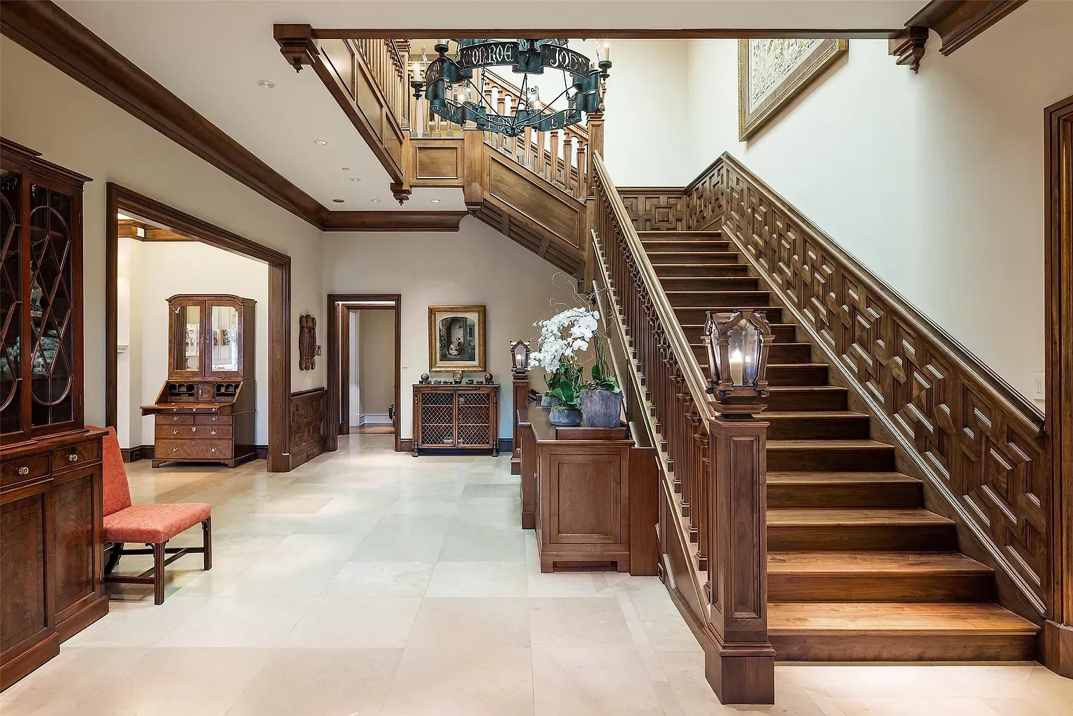 Another grand foyer shot. Sweeping stairs, glossy railings, dramatic entrance energy.