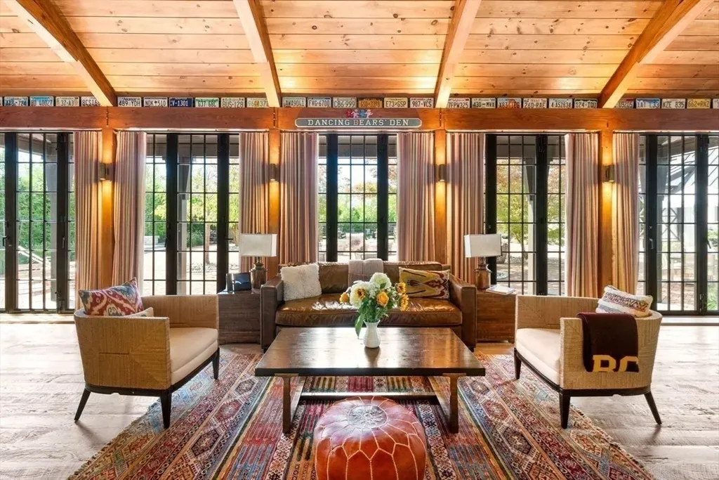 Big windows under warm beams. That light makes everything feel nicer.