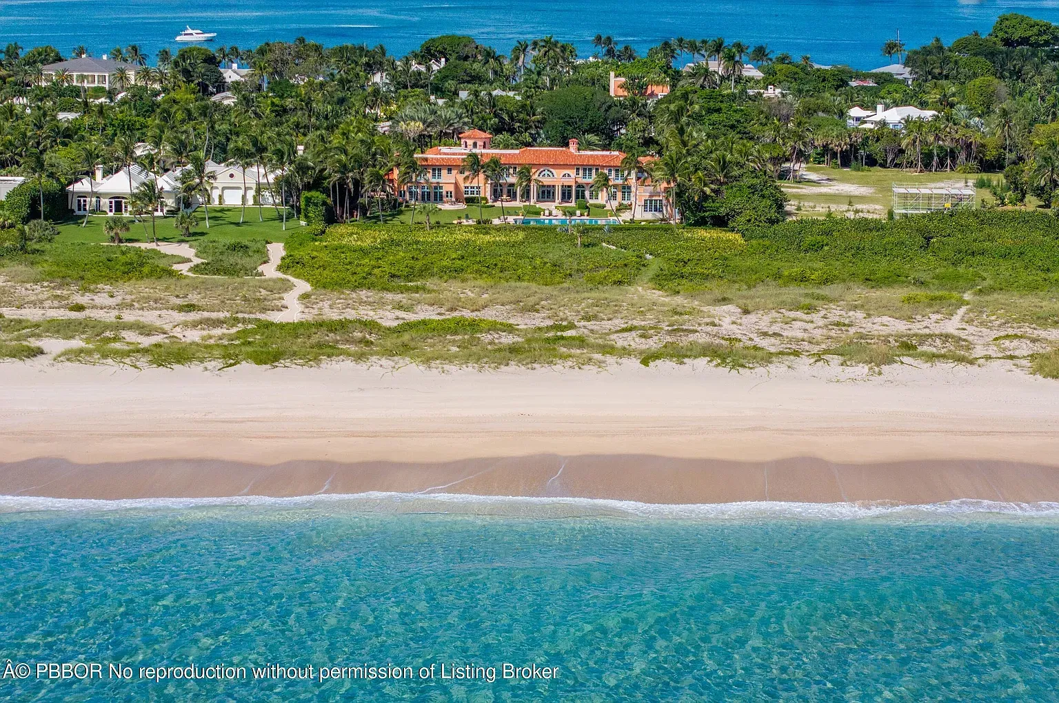 Yellow villa right on the beach, arches and balconies everywhere.