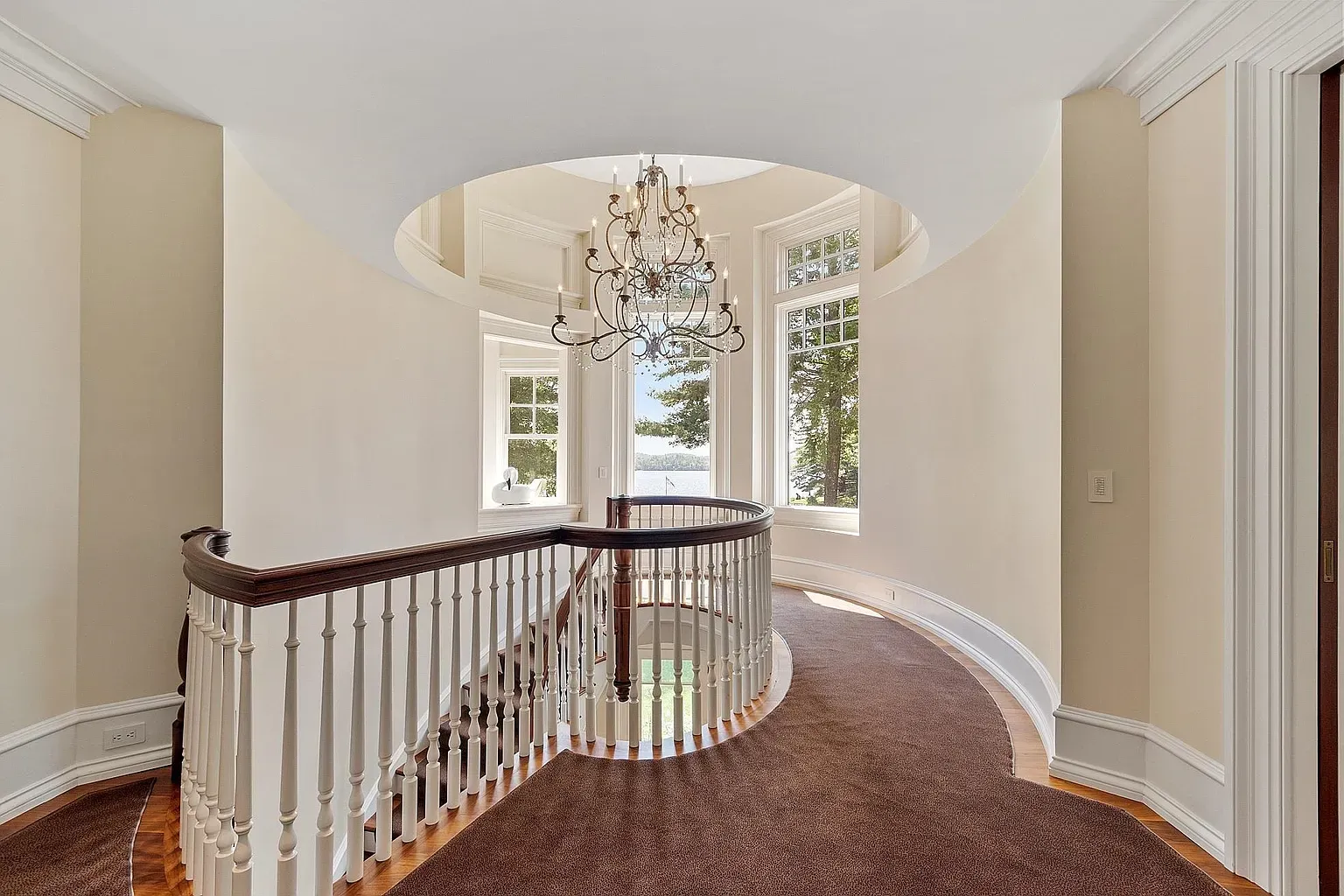 Second staircase cameo, softer walls and a sparkly chandelier moment.