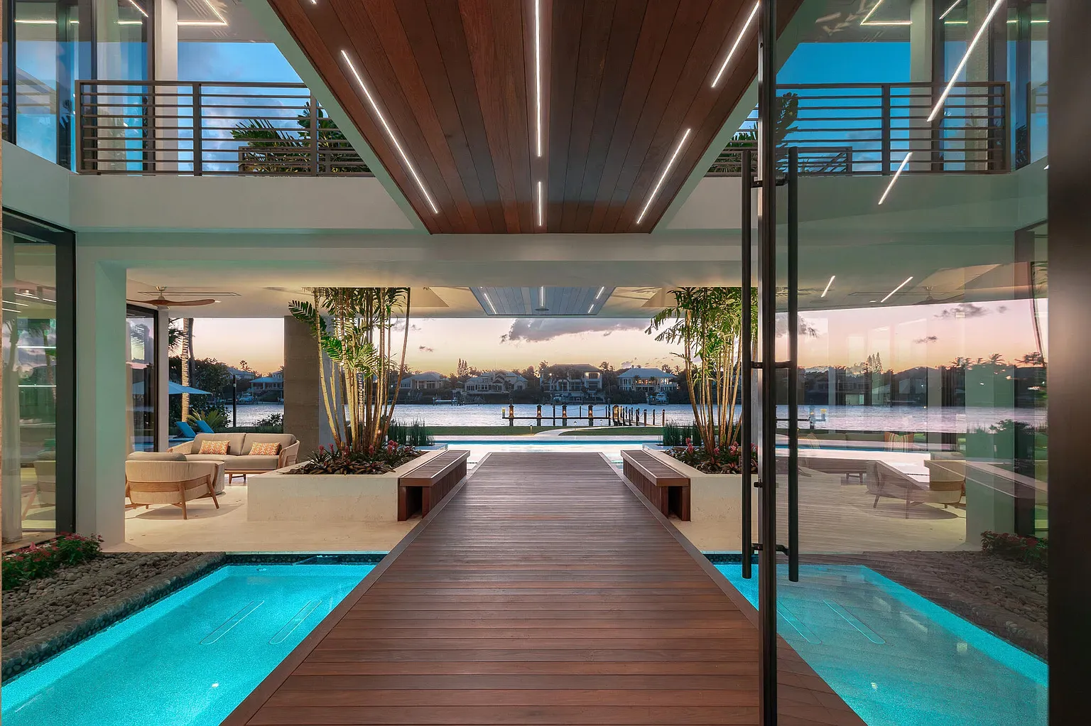 Here's the living room—glass walls everywhere, water view stealing the show.