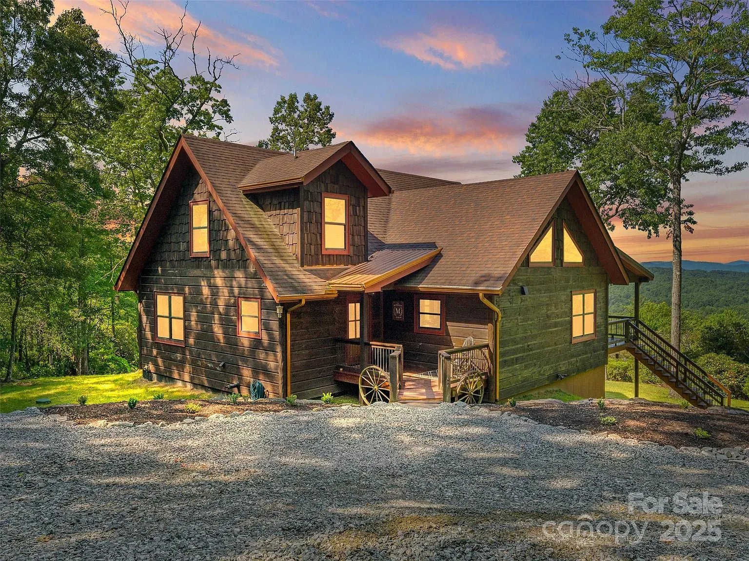 Dark shingle cabin with modern lines. Gables look sharp against the trees.