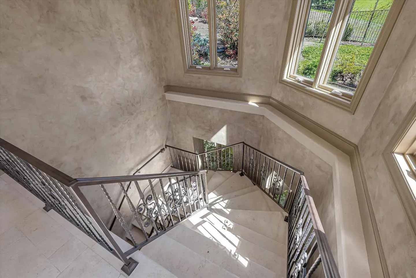 That sweeping staircase wants an entrance moment. The light on the walls is gorgeous.