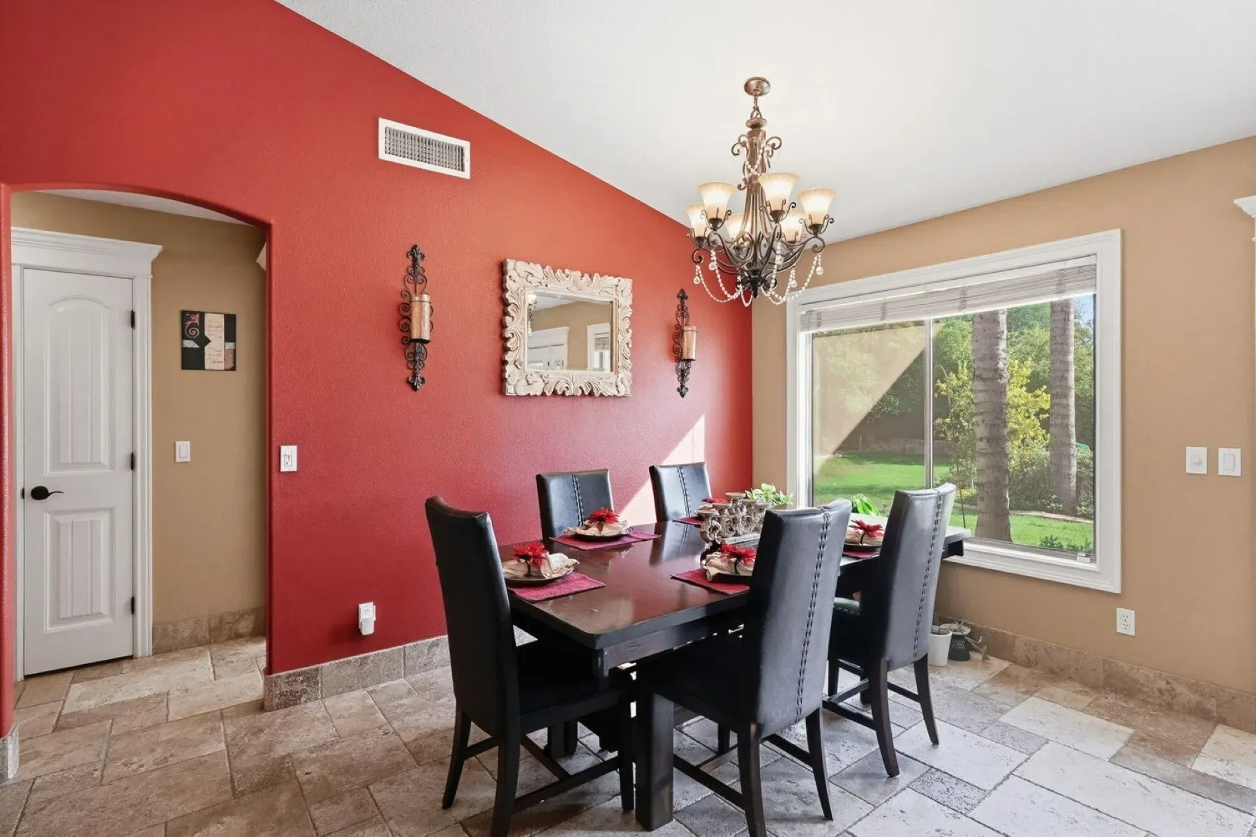 Red accent wall in the dining room—bold but it works here.