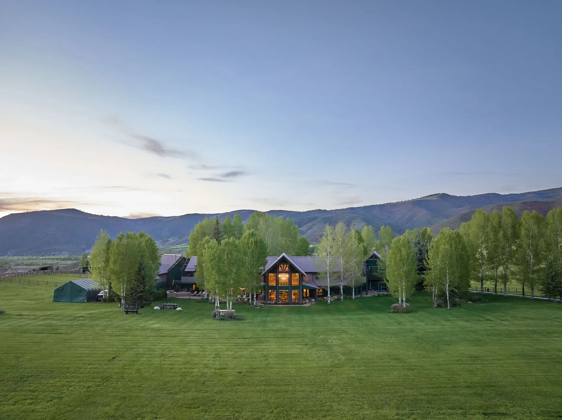 And then the wide exterior shot. huge windows, mountain backdrop. Kinda cinematic.