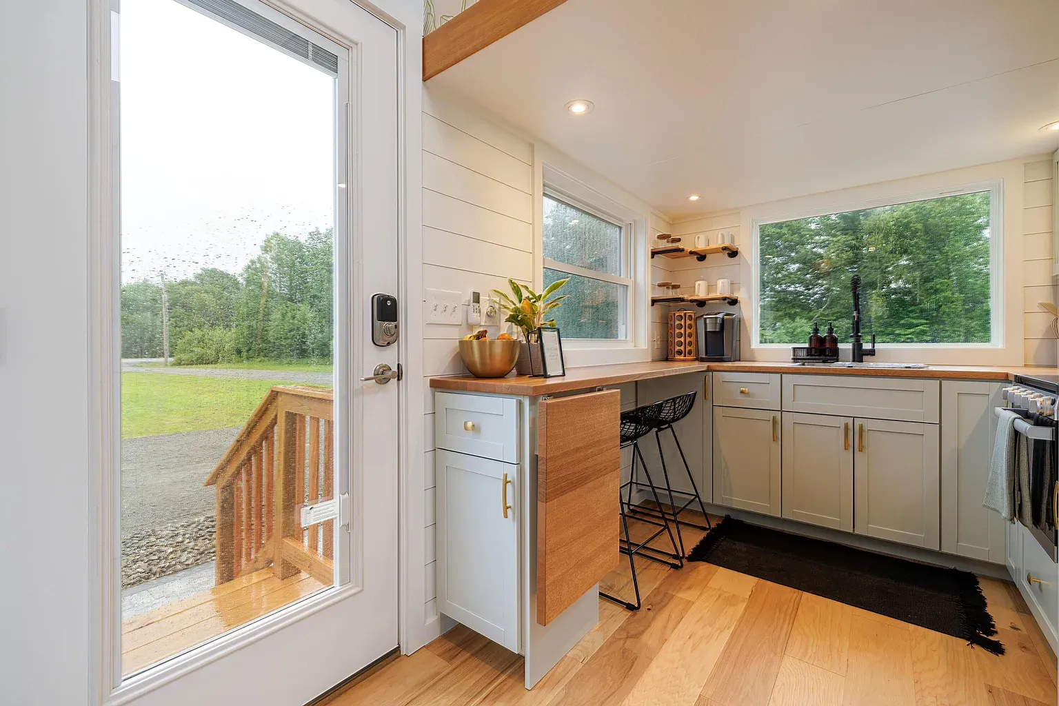 Gray-and-wood looks good here. Tiny kitchen, actually cute.