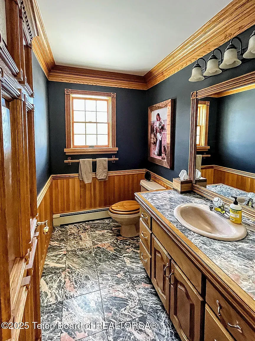 Navy bathroom with wood accents. Bold, but it weirdly works.