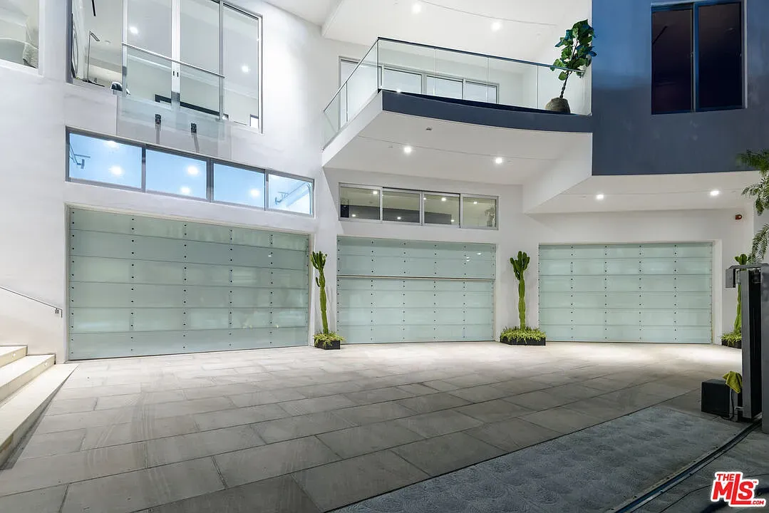 Three glass garage doors. Looks a gallery for cars.