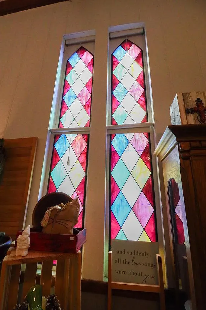 Inside, the diamond-pattern stained glass throws colors everywhere. Tall and narrow, very pretty.