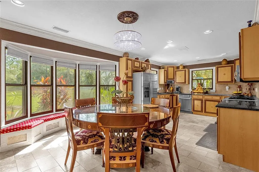 Honey-toned cabinets and an open layout. Big island looks the hangout spot.