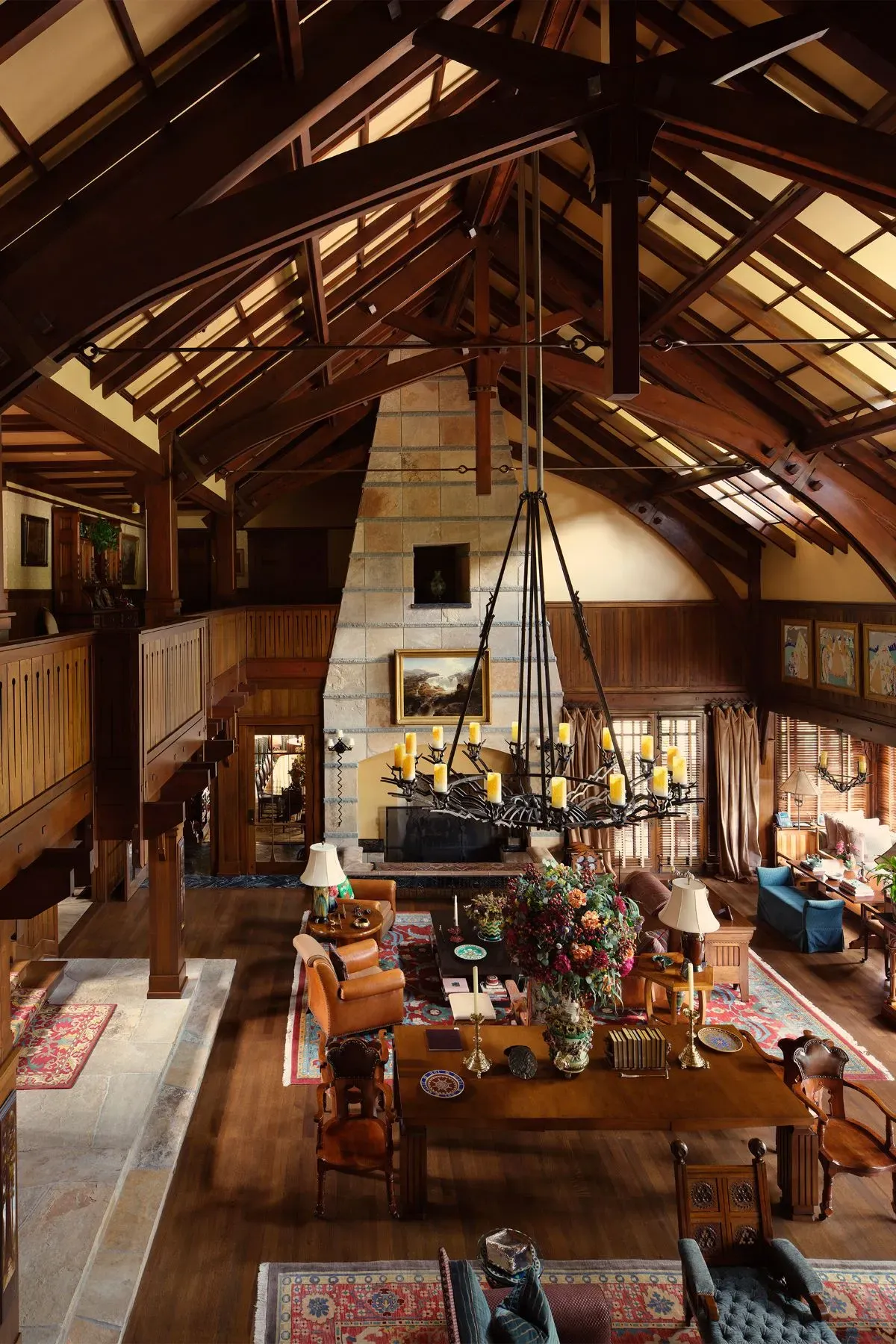 Great room goes full lodge. soaring beams and a whole lot of wood.