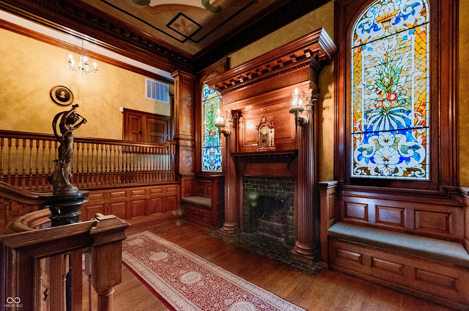 Stained glass bathing the wood paneling in color. Afternoon here would be insane.