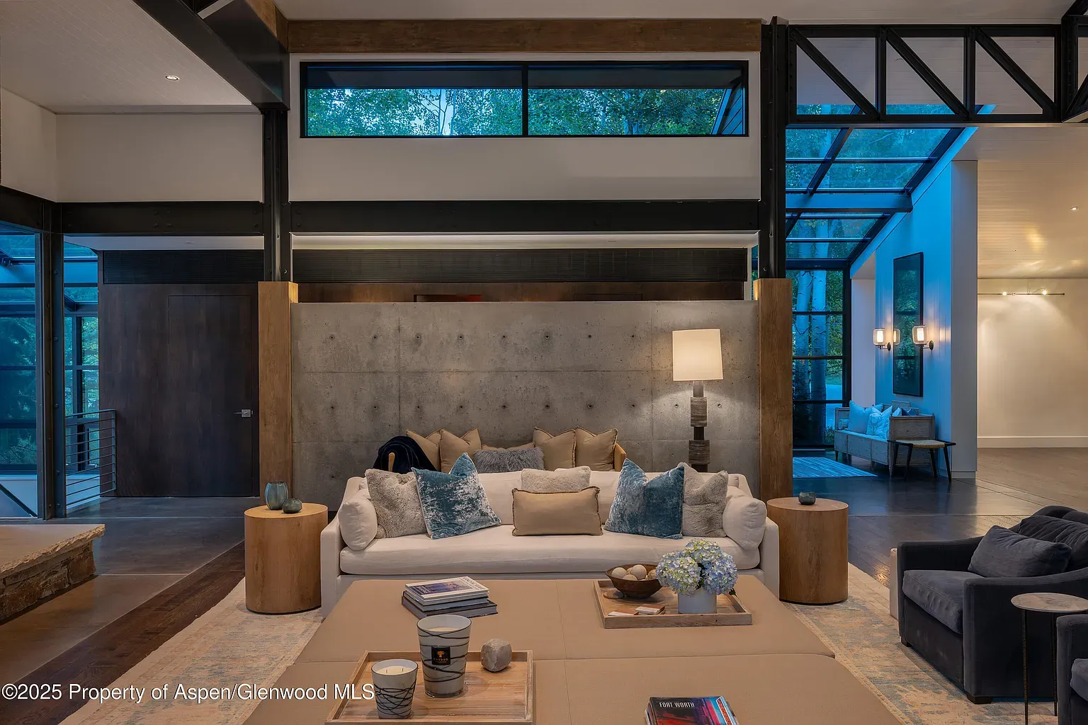 Textured concrete wall behind a cloud‑soft sectional. Cozy meets minimal.