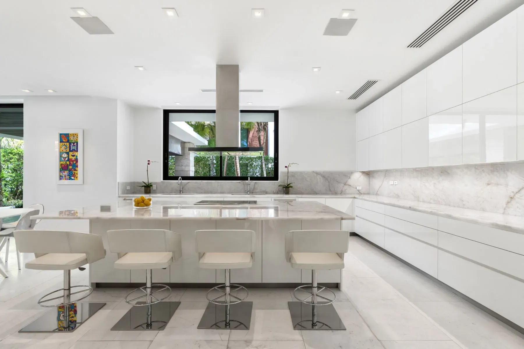 All-white kitchen alert. Glossy cabinets, marble veining doing the most.