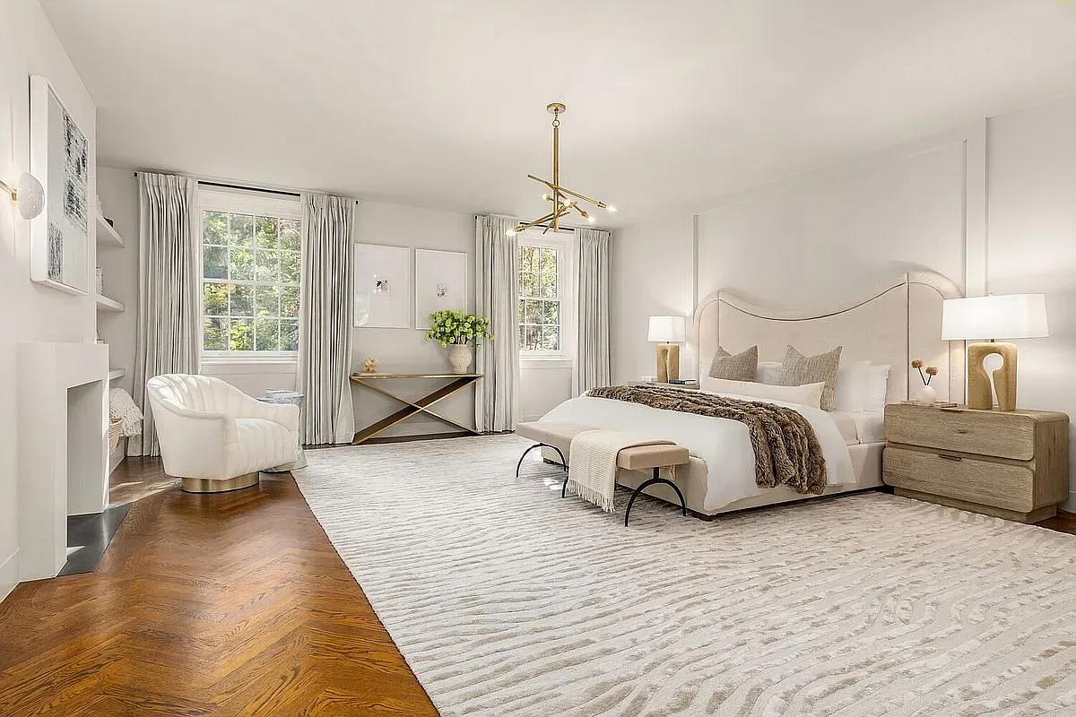 Bedroom’s calm—rich floors, zebra rug wink, modern-meets-classic furniture.